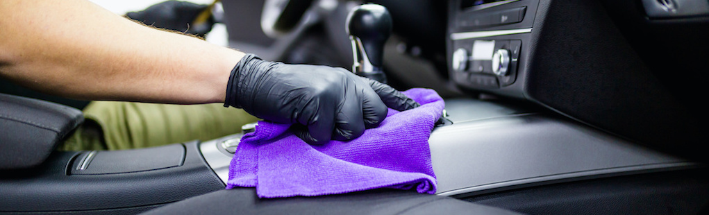 man cleaning car interior